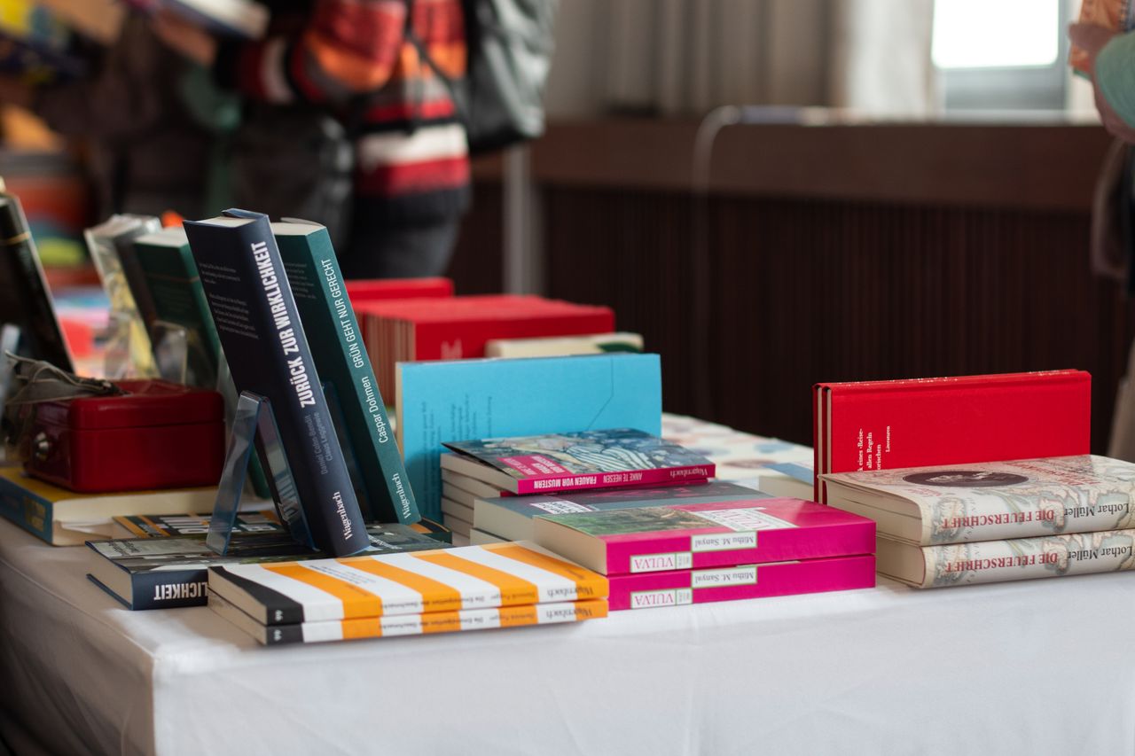 Home Explore a variety of books on display at a Stuttgart book fair event, perfect for literary enthusiasts.